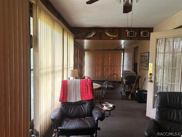 carpeted living room featuring plenty of natural light and ceiling fan