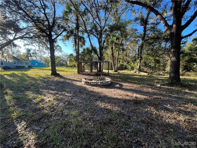 view of yard with a fire pit