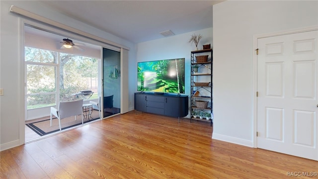 unfurnished living room with ceiling fan, plenty of natural light, and light wood-type flooring