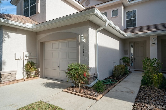 view of exterior entry with a garage