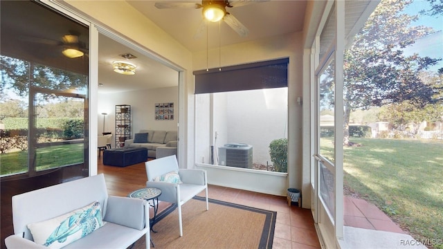 sunroom featuring ceiling fan and a healthy amount of sunlight