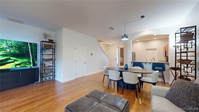 dining space featuring sink and light hardwood / wood-style floors