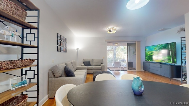 living room with ceiling fan and light hardwood / wood-style floors