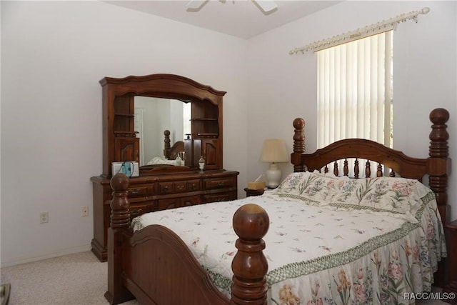 carpeted bedroom with ceiling fan and baseboards