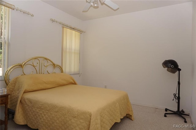 carpeted bedroom with a ceiling fan