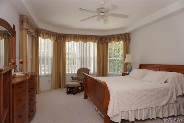 bedroom featuring a ceiling fan and light colored carpet