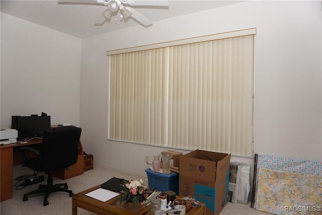 carpeted office space with ceiling fan