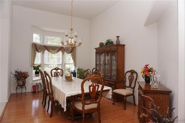 dining area featuring a chandelier and light wood-style flooring