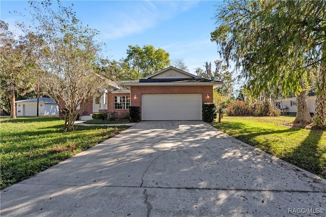 view of front of home with concrete driveway, a front lawn, an attached garage, and stucco siding