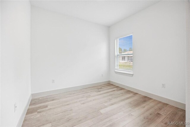 7820 N Sarazen Dr, Citrus Springs, FL 34434 - spare room featuring light wood-style flooring and baseboards