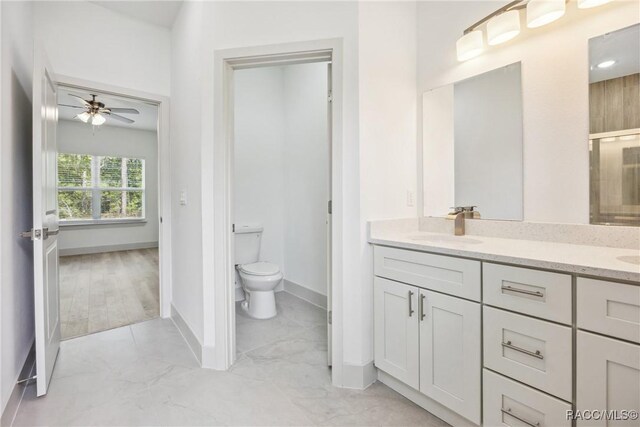 7820 N Sarazen Dr, Citrus Springs, FL 34434 - full bathroom featuring toilet, a ceiling fan, baseboards, double vanity, and marble finish floors