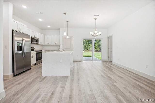 7820 N Sarazen Dr, Citrus Springs, FL 34434 - kitchen with stainless steel appliances, a sink, a chandelier, light countertops, and light wood-type flooring