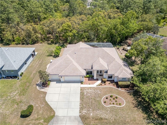 birds eye view of property featuring a view of trees