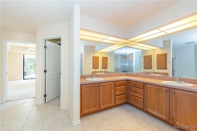 bathroom with tile patterned floors, double vanity, and a sink