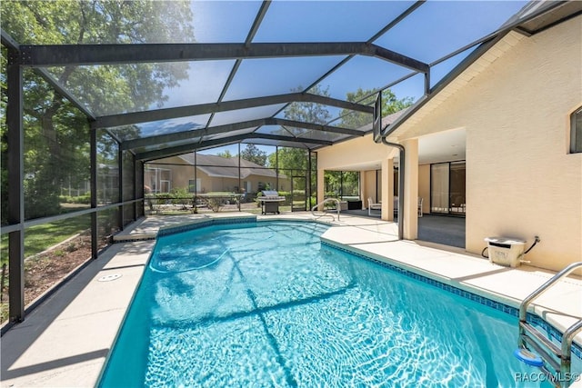 pool featuring a patio area and glass enclosure