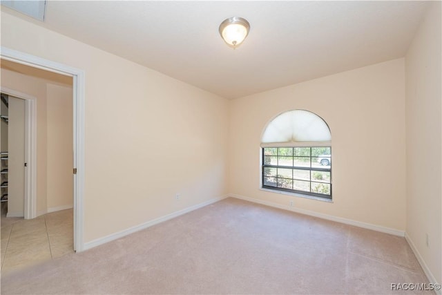 carpeted spare room with baseboards