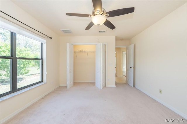 unfurnished bedroom with light colored carpet, baseboards, a ceiling fan, and visible vents