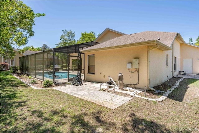 rear view of house featuring a yard, a patio area, an outdoor pool, and stucco siding