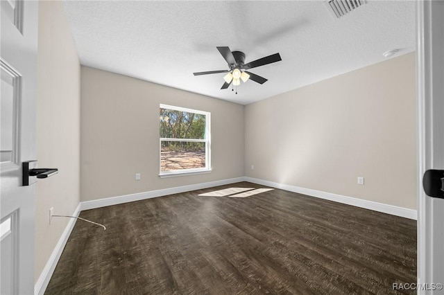 empty room with dark hardwood / wood-style flooring, ceiling fan, and a textured ceiling