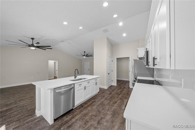 kitchen with sink, white cabinetry, vaulted ceiling, a center island with sink, and stainless steel appliances