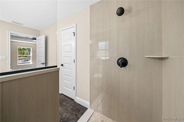 bathroom with tiled shower