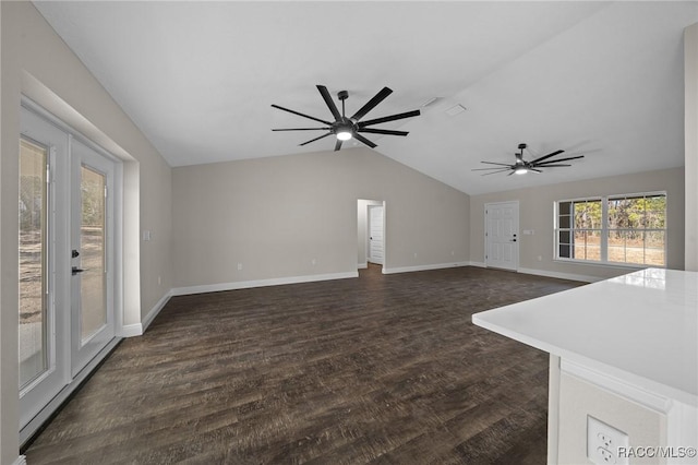 unfurnished living room featuring dark wood-type flooring, ceiling fan, and vaulted ceiling