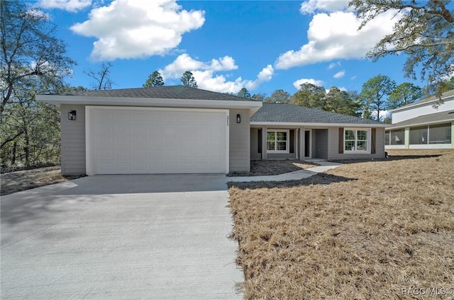 ranch-style home with a garage and a front lawn