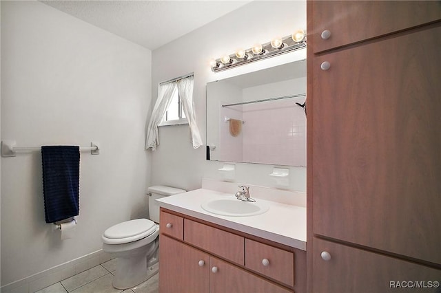 bathroom with tile patterned flooring, vanity, and toilet