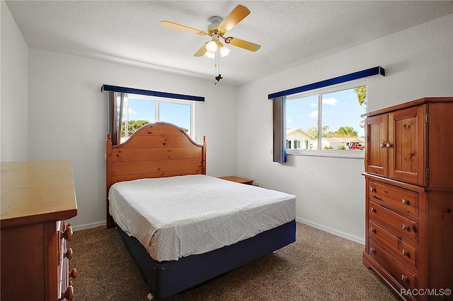 carpeted bedroom featuring baseboards and a ceiling fan