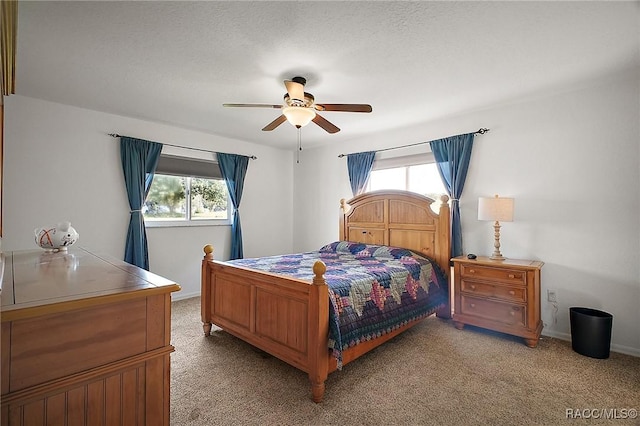 bedroom featuring light carpet and ceiling fan