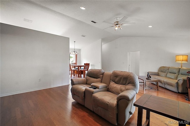 living area featuring lofted ceiling, visible vents, wood finished floors, and ceiling fan