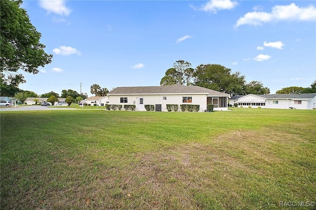 back of house featuring a yard