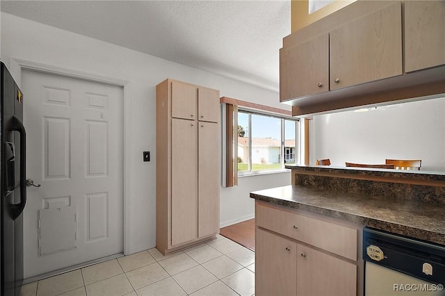 kitchen featuring light tile patterned floors, dishwasher, dark countertops, black fridge with ice dispenser, and light brown cabinets