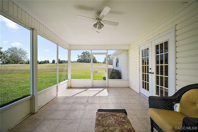 sunroom / solarium with french doors and a ceiling fan