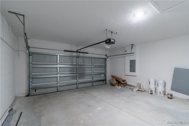 garage featuring electric panel and a garage door opener