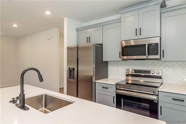 kitchen with backsplash, sink, and stainless steel appliances