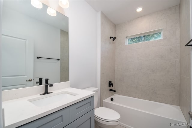 full bathroom featuring vanity, toilet, and tiled shower / bath