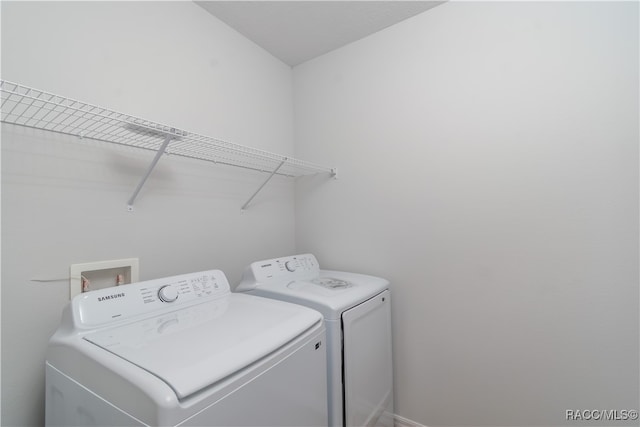 laundry room with washing machine and clothes dryer