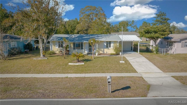 single story home with a front lawn and a carport