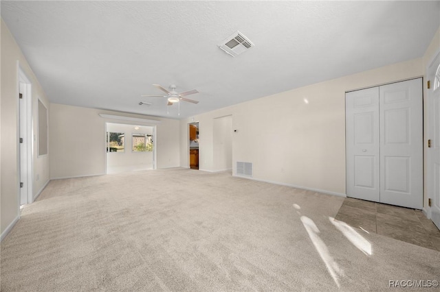 carpeted spare room with ceiling fan