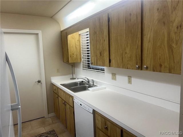 715 E Hartford St Unit 4A, Hernando, FL 34442 - kitchen featuring white dishwasher, a sink, light countertops, light tile patterned floors, and brown cabinets