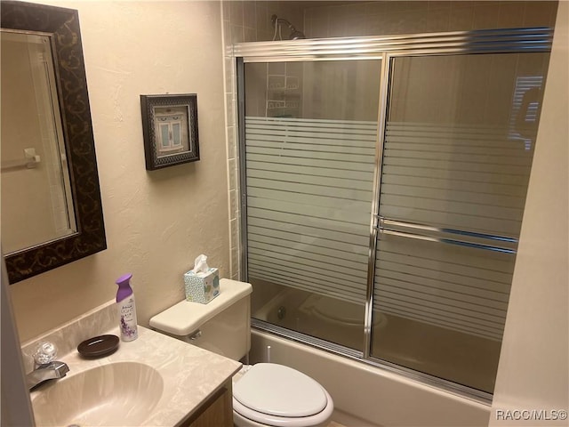 715 E Hartford St Unit 4A, Hernando, FL 34442 - bathroom with vanity, toilet, bath / shower combo with glass door, and a textured wall