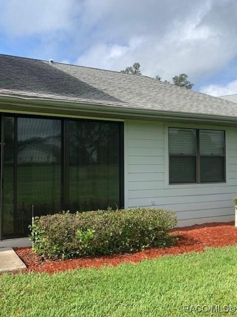 715 E Hartford St Unit 4A, Hernando, FL 34442 - view of property exterior featuring roof with shingles and a lawn