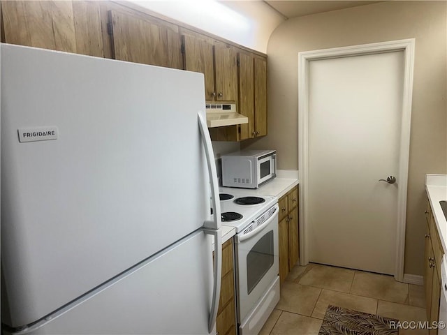 715 E Hartford St Unit 4A, Hernando, FL 34442 - kitchen with white appliances, under cabinet range hood, light countertops, brown cabinets, and light tile patterned flooring