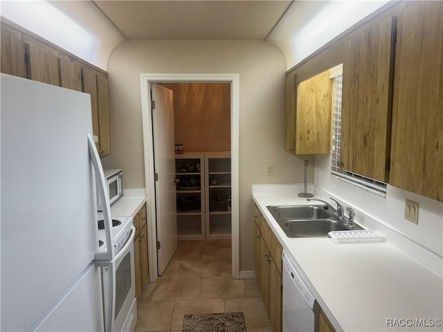 715 E Hartford St Unit 4A, Hernando, FL 34442 - kitchen with white appliances, a sink, brown cabinets, light tile patterned floors, and light countertops