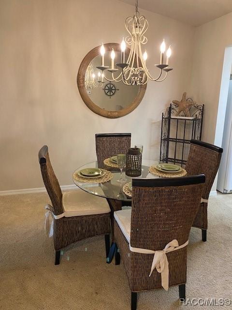 715 E Hartford St Unit 4A, Hernando, FL 34442 - carpeted dining space with a chandelier and baseboards