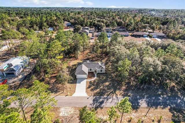 drone / aerial view featuring a forest view