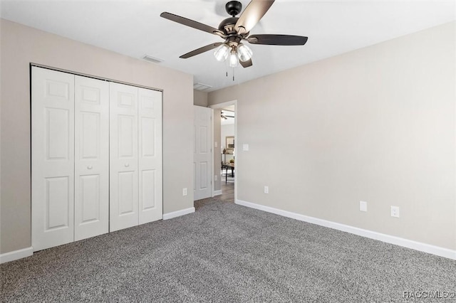 unfurnished bedroom with ceiling fan, visible vents, baseboards, a closet, and carpet