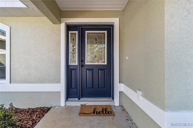 property entrance featuring stucco siding