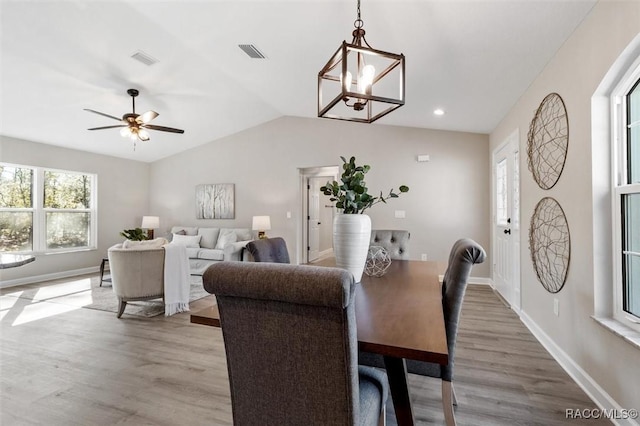 dining room featuring wood finished floors, visible vents, and baseboards